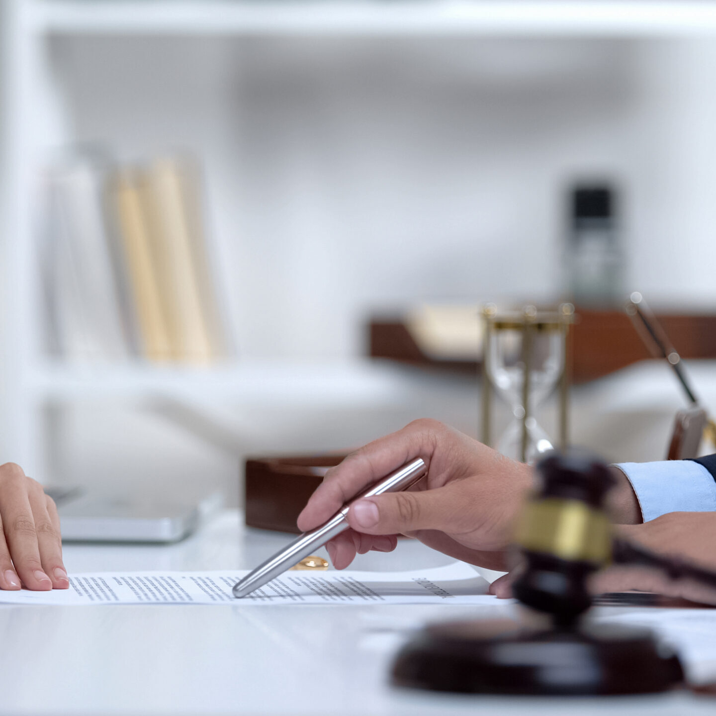 Attorney showing woman where to sign divorce document, legal consultation